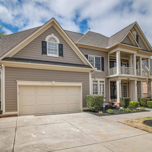 A beautiful suburban home with a spacious front garage and manicured lawns.